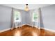 Corner bedroom with hardwood floors, natural light from two windows, and neutral wall colors at 810 Lakeview Dr, Pineville, NC 28134