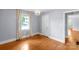 Bedroom featuring hardwood floors, a chandelier, and a window with natural light; view to another room at 810 Lakeview Dr, Pineville, NC 28134