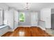 Inviting dining room with hardwood floors, a window seat, a chandelier, and access to a bright kitchen at 810 Lakeview Dr, Pineville, NC 28134