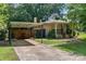 Home with a covered parking area and beautifully landscaped front yard at 810 Lakeview Dr, Pineville, NC 28134
