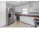 Well-lit kitchen equipped with stainless steel appliances, granite counters, and white cabinetry at 810 Lakeview Dr, Pineville, NC 28134