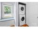 Cozy laundry area with stacked washer/dryer and a window seat with storage at 810 Lakeview Dr, Pineville, NC 28134