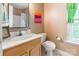 Well-lit bathroom with vanity, toilet, and window at 1274 Winding Path Rd, Clover, SC 29710