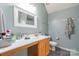 Bright bathroom with wood vanity, large mirror, good lighting, and modern fixtures at 1274 Winding Path Rd, Clover, SC 29710