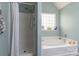 Bathroom features separate tub and shower, with light blue walls at 1274 Winding Path Rd, Clover, SC 29710