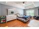 Bright bedroom featuring a tray ceiling, hardwood floors, and a window for natural light at 1274 Winding Path Rd, Clover, SC 29710