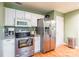 Well-lit kitchen featuring stainless steel appliances, granite countertops, and white cabinets at 1274 Winding Path Rd, Clover, SC 29710