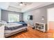 Comfortable main bedroom with wood floors, a ceiling fan and a TV for entertainment at 1274 Winding Path Rd, Clover, SC 29710