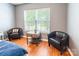 Cozy seating area in the main bedroom features wood floors and a window for natural light at 1274 Winding Path Rd, Clover, SC 29710