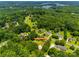 Lush tree line surrounds this property, which boasts a long driveway and inviting front lawn, perfect for outdoor enjoyment at 1388 Aragon Beach Rd, Rock Hill, SC 29732