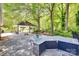 Outdoor kitchen with stone counters and covered patio in a lush backyard at 1388 Aragon Beach Rd, Rock Hill, SC 29732