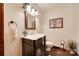 Elegant half bathroom with decorative mirror, ornate vanity, and stylish dark wood flooring at 1388 Aragon Beach Rd, Rock Hill, SC 29732
