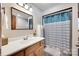 Traditional bathroom with wood vanity, white sink, and shower with blue curtain at 1388 Aragon Beach Rd, Rock Hill, SC 29732