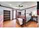 Bedroom with wood floors, four poster bed, ceiling fan and matching wood trim at 1388 Aragon Beach Rd, Rock Hill, SC 29732