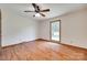 Bright, empty bedroom features a ceiling fan, hardwood floors, and a window at 1388 Aragon Beach Rd, Rock Hill, SC 29732