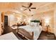 Charming bedroom with wood paneled walls, ceiling fan, and sitting area at 1388 Aragon Beach Rd, Rock Hill, SC 29732