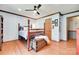 Bedroom with wood floors, four poster bed, ceiling fan and matching wood trim at 1388 Aragon Beach Rd, Rock Hill, SC 29732