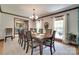 Formal dining room with a large table, decorative chairs, and natural lighting from the windows at 1388 Aragon Beach Rd, Rock Hill, SC 29732