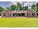 Charming brick home with a manicured lawn, black shutters, and a welcoming front porch at 1388 Aragon Beach Rd, Rock Hill, SC 29732