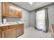 Laundry room with wooden cabinetry, white countertops, and window for natural light at 1388 Aragon Beach Rd, Rock Hill, SC 29732