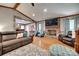 Bright living room featuring a brick fireplace, hardwood floors, and comfortable seating arrangements at 1388 Aragon Beach Rd, Rock Hill, SC 29732