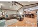 Open living room with hardwood floors, stone accents, a leather sectional, and access to the kitchen at 1388 Aragon Beach Rd, Rock Hill, SC 29732