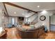 Spacious living room with hardwood floors, a brick fireplace, and a comfortable leather sectional at 1388 Aragon Beach Rd, Rock Hill, SC 29732