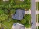Birds eye view of the home and property displaying the roof style, driveway and lush landscaping at 13930 Daltrey Ln, Charlotte, NC 28277