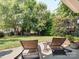 Secluded backyard featuring a hammock, lounge chairs, and lush landscaping at 13930 Daltrey Ln, Charlotte, NC 28277