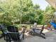 Relaxing backyard with a firepit, Adirondack chairs, and a grassy lawn at 13930 Daltrey Ln, Charlotte, NC 28277