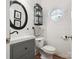 Stylish half bath with shiplap walls, decorative round window, and vanity with vessel sink at 13930 Daltrey Ln, Charlotte, NC 28277