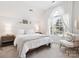Inviting bedroom with a bed, sheer curtains, and natural light from the large arched window at 13930 Daltrey Ln, Charlotte, NC 28277