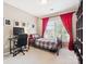Cozy bedroom with bright window, desk, and dark bookshelf at 13930 Daltrey Ln, Charlotte, NC 28277