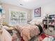 Bright bedroom with large window, plush bedding, and colorful accents at 13930 Daltrey Ln, Charlotte, NC 28277