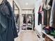 Organized walk-in closet with custom shelving, a bench, and plenty of storage space at 13930 Daltrey Ln, Charlotte, NC 28277