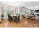 Open-concept dining room area with wood floors and plenty of natural light from large windows at 13930 Daltrey Ln, Charlotte, NC 28277