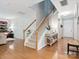 Inviting foyer with a staircase, hardwood floors, and an elegant console table at 13930 Daltrey Ln, Charlotte, NC 28277