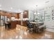Bright and open kitchen with wood cabinets, stainless steel appliances, and an adjacent dining area at 13930 Daltrey Ln, Charlotte, NC 28277