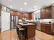 Spacious kitchen with a center island, stainless steel appliances, and wood flooring at 13930 Daltrey Ln, Charlotte, NC 28277