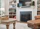 Inviting living room with a fireplace, built-in bookshelves, and comfortable seating at 13930 Daltrey Ln, Charlotte, NC 28277