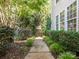 Charming walkway with lush landscaping leading to the home's entrance, enhancing curb appeal at 13930 Daltrey Ln, Charlotte, NC 28277