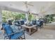 Spacious covered patio featuring comfortable outdoor seating and ceiling fans at 13930 Daltrey Ln, Charlotte, NC 28277