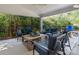 Cozy covered patio with comfortable seating and a wooded view at 13930 Daltrey Ln, Charlotte, NC 28277