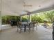 Spacious covered patio featuring a ceiling fan and outdoor seating at 13930 Daltrey Ln, Charlotte, NC 28277