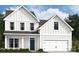 Charming two-story home with a white exterior, black door and a two car garage at 1488 Kate Cecil Way, York, SC 29745