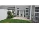 This backyard shows a quaint patio, gray siding and a white fence at 162 Autumn Falls Dr, Lake Wylie, SC 29710