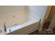 A modern bathtub with chrome hardware and fixtures, complemented by wood-look flooring at 162 Autumn Falls Dr, Lake Wylie, SC 29710
