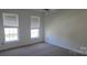 Bedroom featuring neutral walls, carpet, and two large windows at 162 Autumn Falls Dr, Lake Wylie, SC 29710