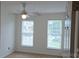 A bright bedroom featuring a ceiling fan and windows, creating a serene and inviting space at 162 Autumn Falls Dr, Lake Wylie, SC 29710
