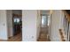 Open hallway with kitchen view, stainless appliances, wood floors, and stairway at 162 Autumn Falls Dr, Lake Wylie, SC 29710